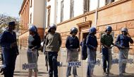 Riot police officers keep watch outside the Tredgold Building Magistrate court in Bulawayo, Zimbabwe, August 19, 2019. REUTERS/Philimon Bulawayo