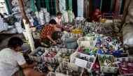 This picture taken on July 22, 2019 shows villagers sifting through plastic waste in the village of Bangun.  / AFP / Juni Kriswanto / 