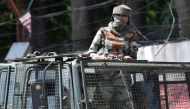 (FILES) In this file photo taken on August 18, 2019, an Indian army soldier stands alert in a truck while travelling in a convoy in Srinagar. AFP / Punit Paranjpe 
 