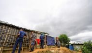 In this file photo taken on July 22, 2019, Bangladesh police personnel stand as they patrol inside Kutupalong refugee camp in Ukhia.  AFP / Munir UZ ZAMAN 