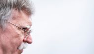 FILE PHOTO: US National Security Advisor John Bolton listens as US President Donald Trump.   AFP / Brendan Smialowski
