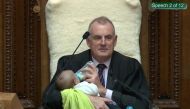 Screenshot from a Parliament broadcast of New Zealand Speaker Trevor Mallard feeding a Member of Parliament’s baby during a parliamentary session in Wellington August 21, 2019. New Zealand Parliament and Speaker's Office/Handout via Reuters