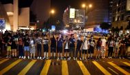 Protesters form a human chain on the street outside the Hong Kong Cultural Centre in Hong Kong on August 23, 2019.