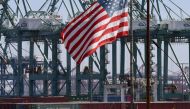 In this file photo taken on September 29, 2018 the US flag flies over Chinese shipping containers that were unloaded at the Port of Long Beach, in Los Angeles County. (AFP / Mark RALSTON)