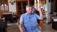 Former Hungarian Prime Minister Miklos Nemeth gestures as he speaks with a journalist during an AFP interview in his summer house close to Tihany at the Balaton Lake on July 30, 2019.  AFP / Attila Kisbenedek