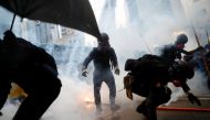 Demonstrators are surrounded by tear gas during a protest in Tsuen Wan, in Hong Kong, China, August 25, 2019. REUTERS/Kai Pfaffenbach