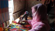 Shofika Begum, a Rohingya who was raped two years ago in Myanmar and today leads a group of female tailors in the refugee camps in South East Bangladesh who sell clothes for a living, stitches a dress at her home on August 5, 2019. Thomson Reuters Foundat