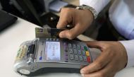 A salesman registers a credit card for a customer at a shop in Peshawar, April 1, 2019. Reuters/Fayaz Aziz