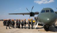 National Force military firefighters stand in line to board a plane to Rondonia northern Brazil, to help fight fires in the Amazon rainforest at the Military Air Base in Brasilia, on August 24, 2019.   AFP / Sérgio Lima