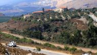 A photograph taken from El-Hamames hilltop in southern Lebanon shows vehicles belonging to the United Nations Interim Forces in Lebanon (UNIFIL) patrolling along the border with Israel, on August 26, 2019.  
