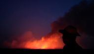 A man is seen on a burning tract of the Amazon jungle in Canarana, Mato Grosso state, Brazil August 26, 2019. REUTERS/Lucas Landau 