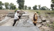 Kiran Aherwal, a Jal Saheli, or a woman water friend, supervises the making of a water outlet in Agroutha village of Bundelkhand, India on July 16, 2019. Thomson Reuters Foundation/Annie Banerji