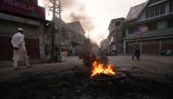 Kashmiri people walk past burning tyres during a protest after the scrapping of the special constitutional status for Kashmir by the Indian government, in Srinagar, August 27, 2019. Picture taken on August 27, 2019. REUTERS/Danish Ismail