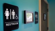 Unisex signs hanging outside bathrooms at Toast Paninoteca in Durham, North Carolina, May 9 2016.  AFP / Getty Images North America / Sara D Davis