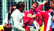 Sebastian Vettel (right) and Lewis Hamilton share a light moment during qualifying session for the F1 Grand Prix of Canada, in this June 08, 2019 file photo.