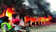 A motorist ride past a burning building after hundreds of demonstrators marched near Papua's biggest city Jayapura on August 29, 2019, where they set fire to a regional assembly building and hurled rocks at shops and hotels. AFP / Indra Thamrin Hatta

