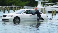 Weston Rice drives through a flooded parking lot as he prepares to drop his jet ski into the water at the Haulover Marine Center before the arrival of Hurricane Dorian on August 30, 2019 in Miami Beach. Joe Raedle/Getty Images/AFP 