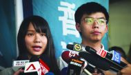 Pro-democracy activists Agnes Chow (L) and Joshua Wong (R) speak to the press after they were released on bail at the Eastern Magistrates’ Courts in Hong Kong on August 30, 2019. AFP / Lillian Suwanrumpha
