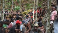 This handout picture taken and released on September 1, 2019, by the Indonesian military shows a group of Papuans, who took part in recent mass protests and currently seeking military's help to return to their homes, in Jayapura. / AFP / The Indonesian Mi