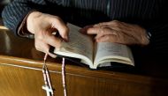 A believer reads the Bible during mass at St Josephs’ Church, a government-sanctioned Catholic church, in Beijing, October 1, 2018. Reuters / Thomas Peter