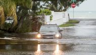 A car drives through a flooded street after the effects of Hurricane Dorian arrived in Nassau, Bahamas, September 2, 2019. REUTERS/John Marc Nutt