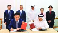 Qatar Chamber Chairman Sheikh Khalifa bin Jassim Al Thani (standing, centre) and Fan Ruiping (second left), the head of the visiting Chinese delegation, witnessing the signing of a cooperation agreement between Taleb Group and Chengdu Hi-tech Zone at QC h