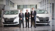 Officials pose with the newly-unveiled Toyota Granvia luxury van.