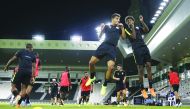 Qatari players take part in a practice session at the Al Sadd Stadium, yesterday, on the eve of their match against Afghanistan.