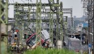 A train is seen derailed after a collision with a truck at a crossing in Yokohama, Kanagawa Prefecture on September 5, 2019. A train and a truck collided at a crossing near Tokyo, injuring 35 people, with at least one person seriously hurt, authorities sa