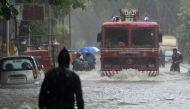 A fire engine drives through a flooded road during heavy rain showers in Mumbai on September 4, 2019. / AFP / PUNIT PARANJPE