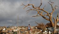A man walks among debris at the Mudd neighborhood, devastated after Hurricane Dorian hit the Abaco Islands in Marsh Harbour, Bahamas, September 6, 2019. Reuters/Marco Bello