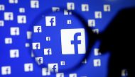 FILE PHOTO: A man poses with a magnifier in front of a Facebook logo on display in this illustration taken in Sarajevo, Bosnia and Herzegovina, December 16, 2015. REUTERS/Dado Ruvic/Illustration/File Photo