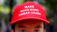 A protester is seen wearing a cap that reads, 