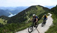(FILES) This file photo taken on August 5, 2019 shows Ursula and Robert Werner cycling on their electric bikes as they are on their way up to the Herzogstand mountain in the Alp mountains near the village Walchensee, southern Germany. AFP / Christof Stach