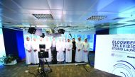H E Ali bin Ahmed Al Kuwari (third right, front row), Minister of Commerce and Industry, with QFC and Bloomberg officials during the launch event.