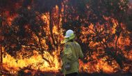 Firefighters battle bushfires in Angourie, northern New South Wales, Australia, September 10, 2019. AAP Image/Jason O'Brien/via REUTERS 