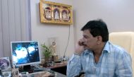 In this file photo taken on March 14, 2005 Mumbai police officer Pradeep Sharma watches a screen showing the entrance to his house in Mumbai. India's real-life Dirty Harry who made his name by gunning down gangsters in the streets of Mumbai has resigned a