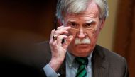 John Bolton adjusts his glasses as US President Donald Trump speaks while meeting with NATO Secretary General Jens Stoltenberg in the Oval Office at the White House, April 2, 2019. Reuters/Joshua Roberts