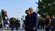 US President Donald Trump and First Lady Melania Trump, with US Secretary of Defense Mark Esper (R) and his wife Leah Esper (2nd R), lay a wreath during a ceremony marking the 18th anniversary of the 9/11 attacks, on September 11, 2019, at the Pentagon in