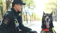 Representative image: Dog handler Ahn Seong-heon with Larry, a seven-year-old German shepherd police dog killed in the line of duty by a snake. AFP /Daegu Metropolitan Police Agency