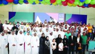 Volunteers pose for a picture along with officials of the organising committee of IAAF World Athletics Championships during the opening ceremony of the Volunteers Entertainment Tent in Doha yesterday. 