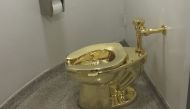 A fully functioning solid gold toilet, made by Italian artist Maurizio Cattelan, in this file photo taken on September 15, 2016. AFP / William Edwards
