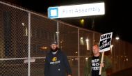 Members of the United Auto Workers (UAW) who are employed at the General Motors Co. Flint Assembly plant in Flint, Michigan, walk in front of the plant as they go on strike early on September 16, 2019. AFP / JEFF KOWALSKY