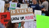 Teenagers and students take part in a climate protest outside the White House (background) in Washington on September 13, 2019. AFP / Nicholas Kamm
