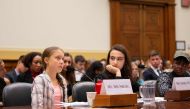 Swedish environment activist Greta Thunberg (L) speaks as This Is Zero Hour co-founder Jamie Margolin (C) and Alliance for Climate Education fellow Vic Barrett (R) look on during a joint hearing before the House Foreign Affairs Committee, Europe, Eurasia,