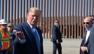 US President Donald Trump (L) speaks to the media during a visit the US-Mexico border fence in Otay Mesa, California on September 18, 2019. / AFP / Nicholas KAMM