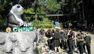 Zoo workers lay flowers at a Panda statue days after the 19-year-old panda Chuang Chuang died at the Chiang Mai zoo, Chiang Mai, Thailand, September 18, 2019. Dailynews/ via REUTERS