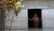 Saju Begum, a flood-affected woman poses for a picture inside her house in Jamalpur, Bangladesh, July 21, 2019. Reuters/Mohammad Ponir Hossain
