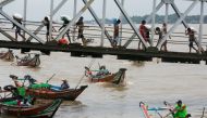 People from Dala township arriving by boat in Yangon after crossing the Yangon River. AFP / Sai Aung Main