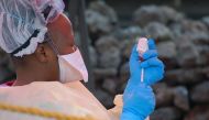 (FILES) In this file photograph taken on August 7, 2019, a nurse prepares a vaccine against Ebola in Goma, eastern Democratic Republic of the Congo. AFP / Augustin Wamenya 